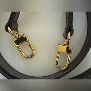 Brown leather cross-body purse or phone case strap.